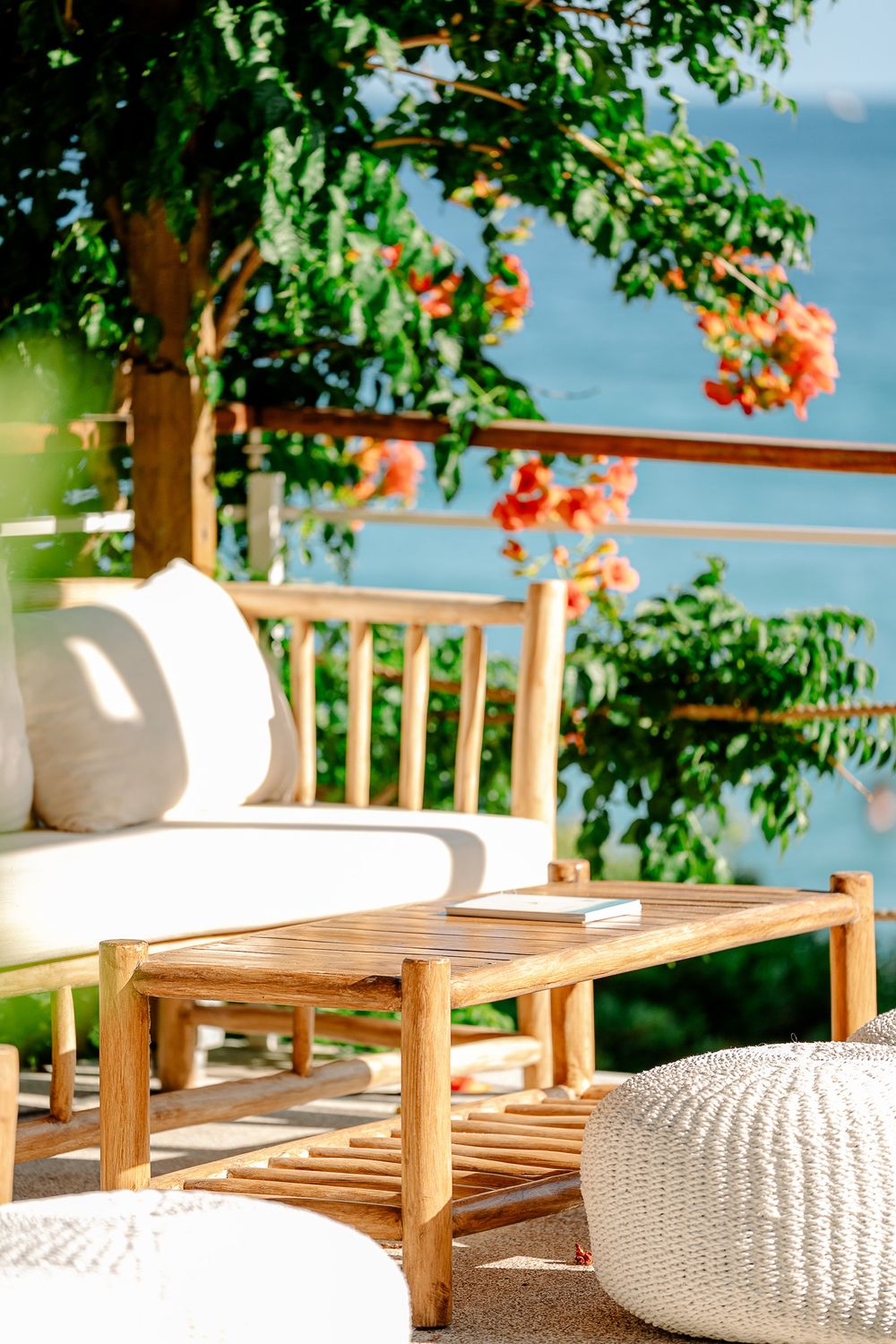 Wooden outdoor chair and table under natural shade in a relaxed summer setting.