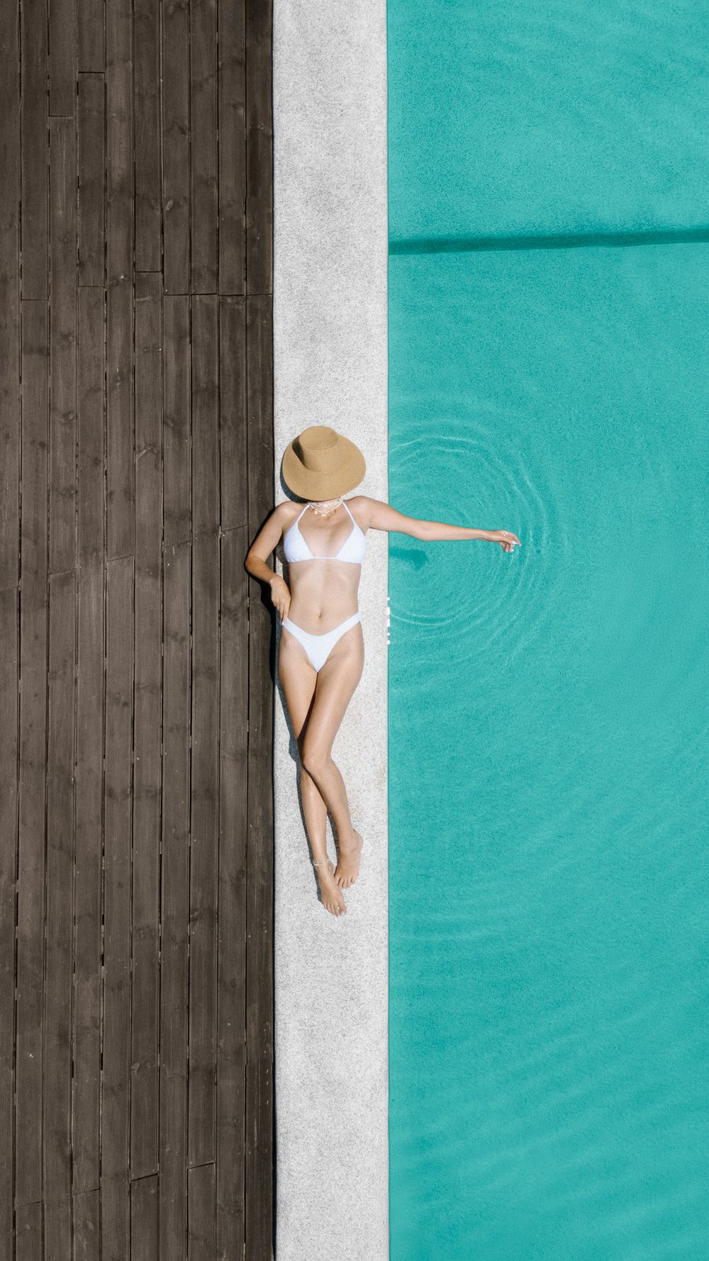 Minimal top-down pool moment with calm posture and clean lines.