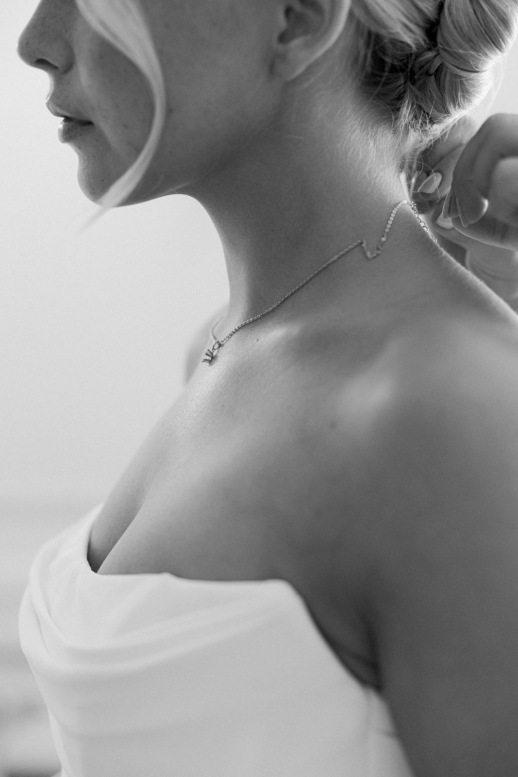 Black and white close-up portraits showing elegant bridal details including jewelry, hair styling and dress necklines.
