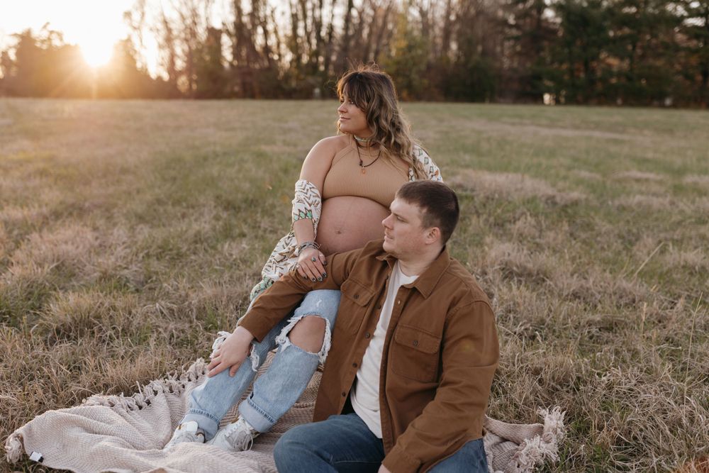 Romantic maternity photo on blanket in field during golden hour. Virginia/ North Carolina Maternity Session