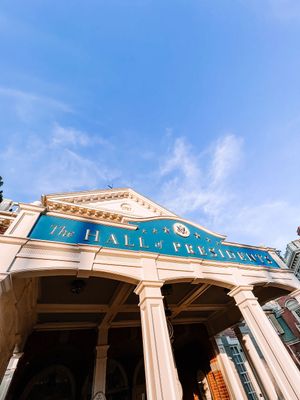 A panoramic view of Nyhavn's historic waterfront buildings with colorful facades under a bright blue sky in Copenhagen.