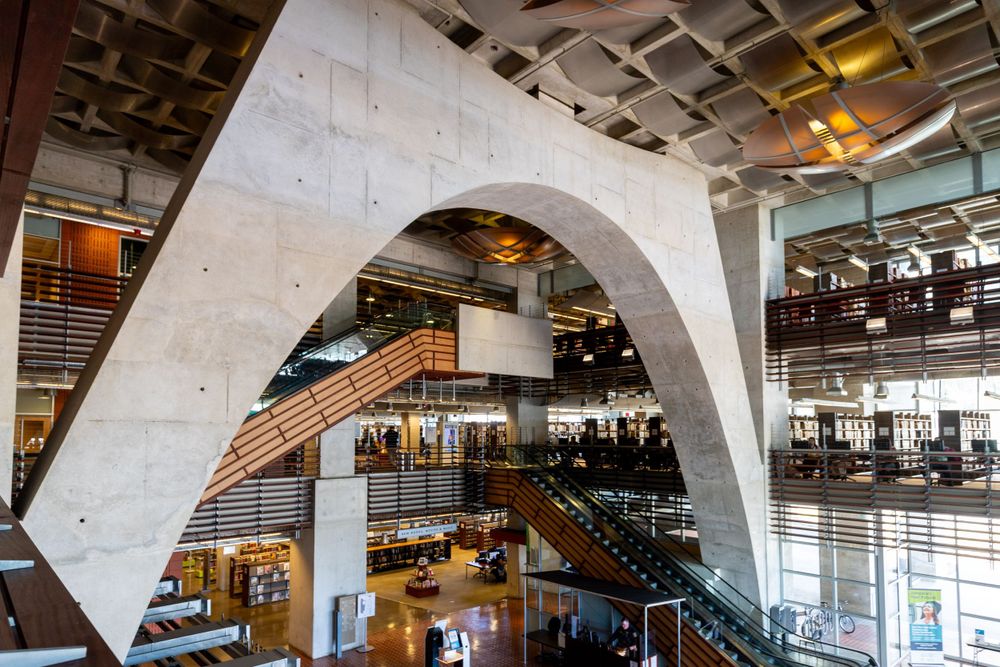 Dramatic concrete arch structure in the San Diego Public Library with natural lighting.