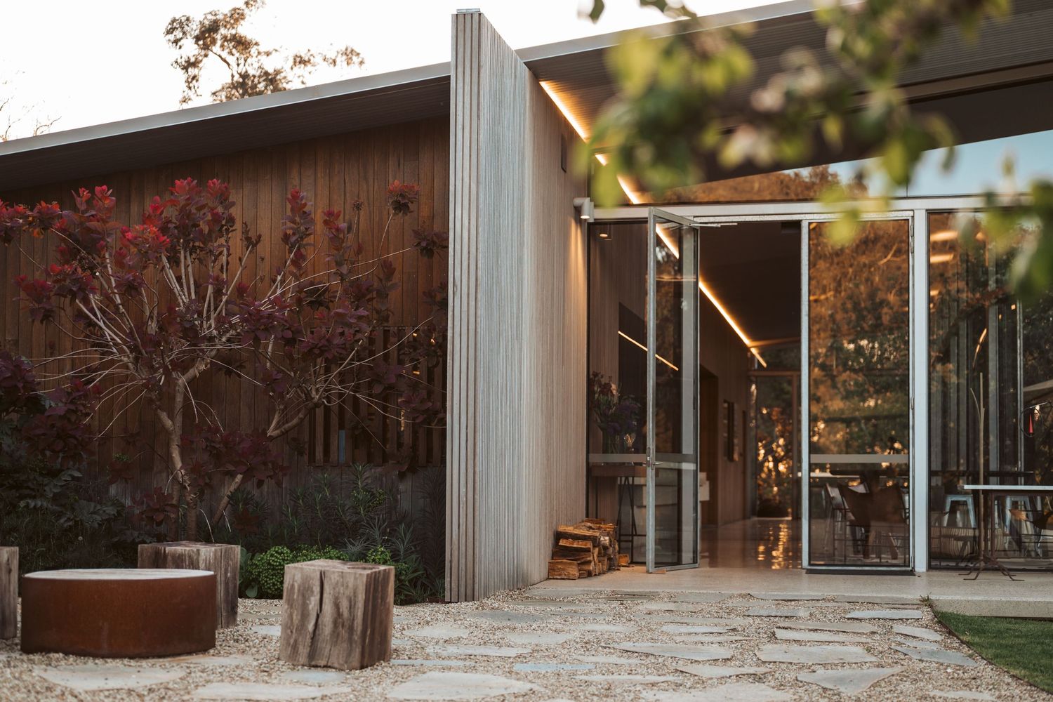 Boutique accommodation exterior photography featuring contemporary architecture and warm twilight lighting