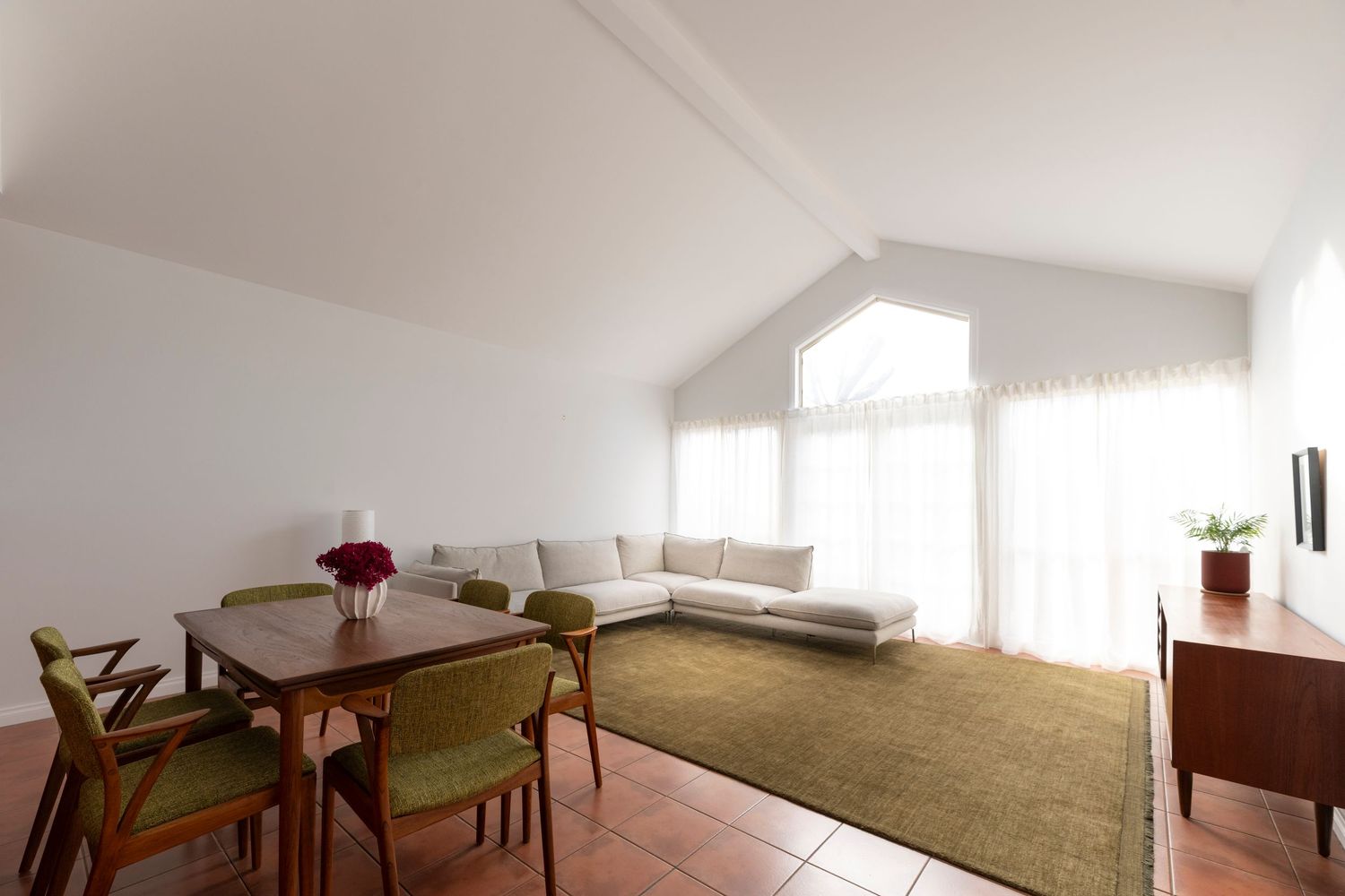 Accommodation interior photography showcasing vaulted ceilings, soft natural light and contemporary guest lounge design
