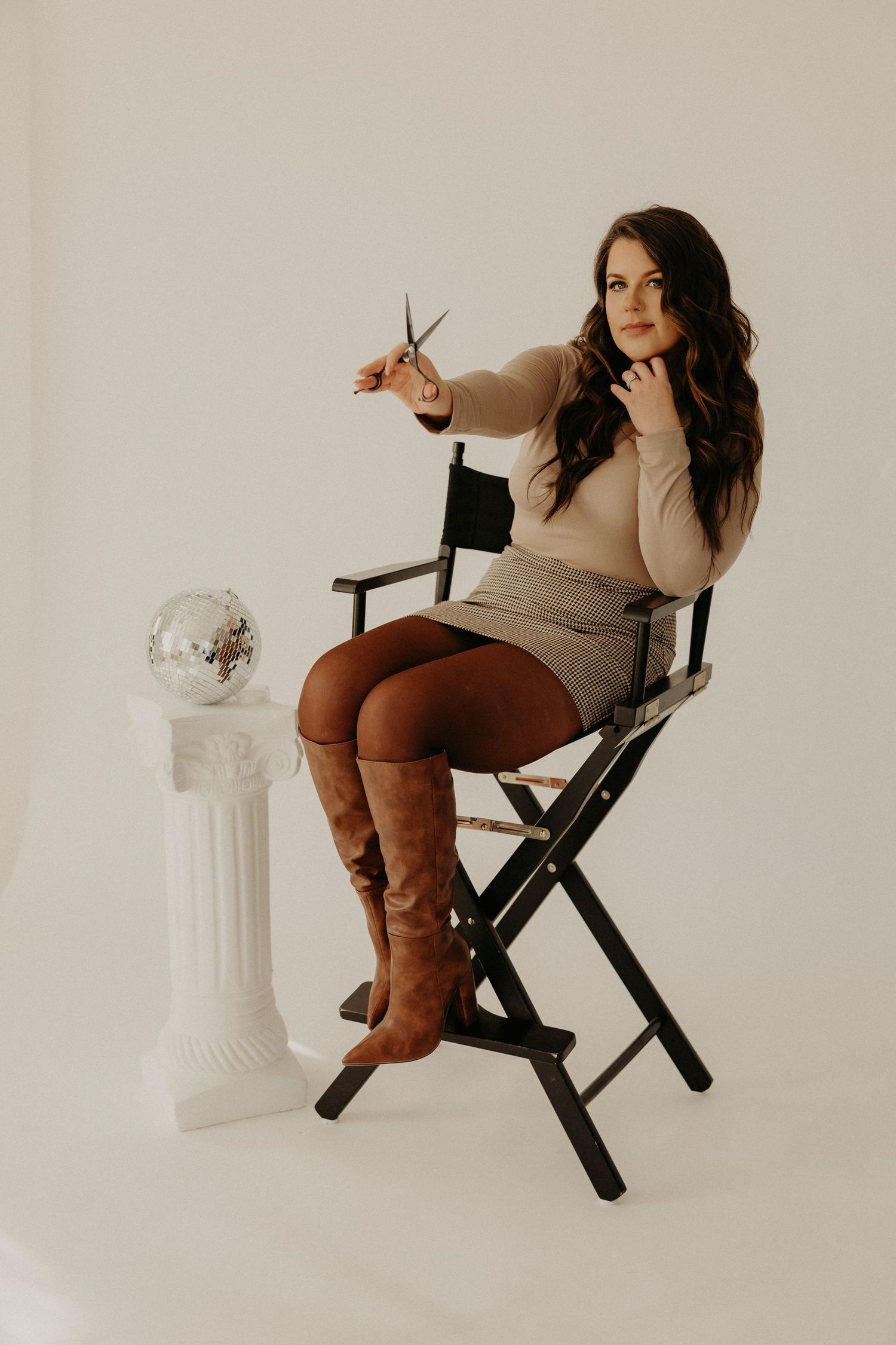 Professional branding photoshoot of a woman entrepreneur in a modern office setting.