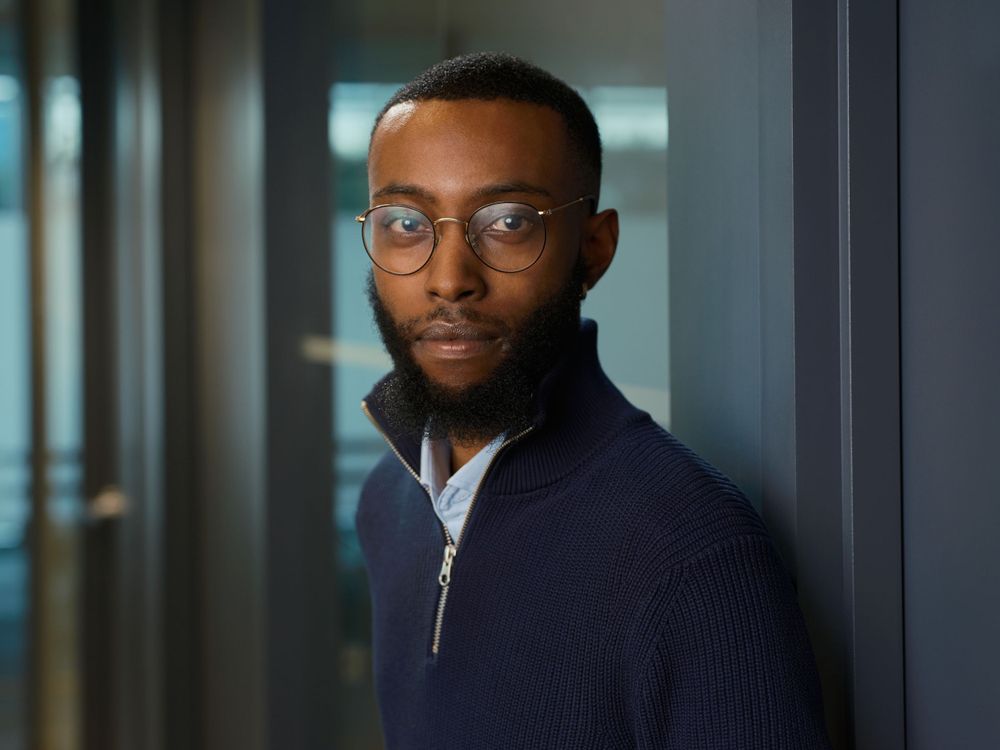 Professional portrait of a man in dark sweater with serious expression and moody lighting — business photography by Khoi Ly in Vancouver.