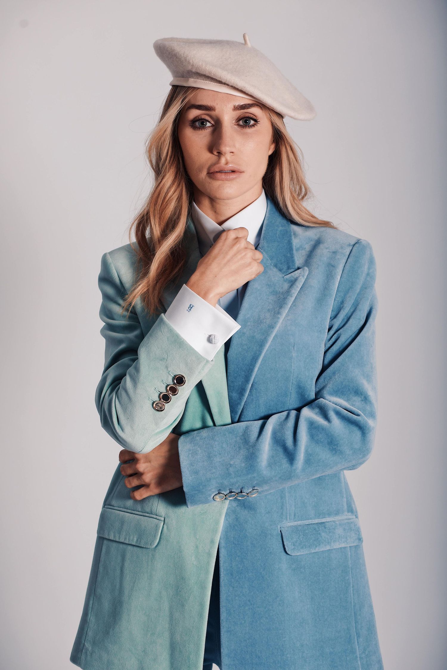 Stylish trendy powder blue blazer with crisp white shirt and beige beret in elegant fashion portrait.