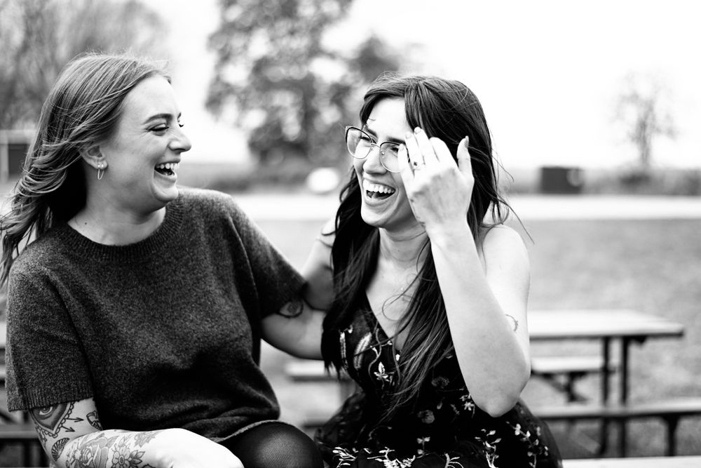 Series of candid black and white photos showing couple laughing together outdoors.