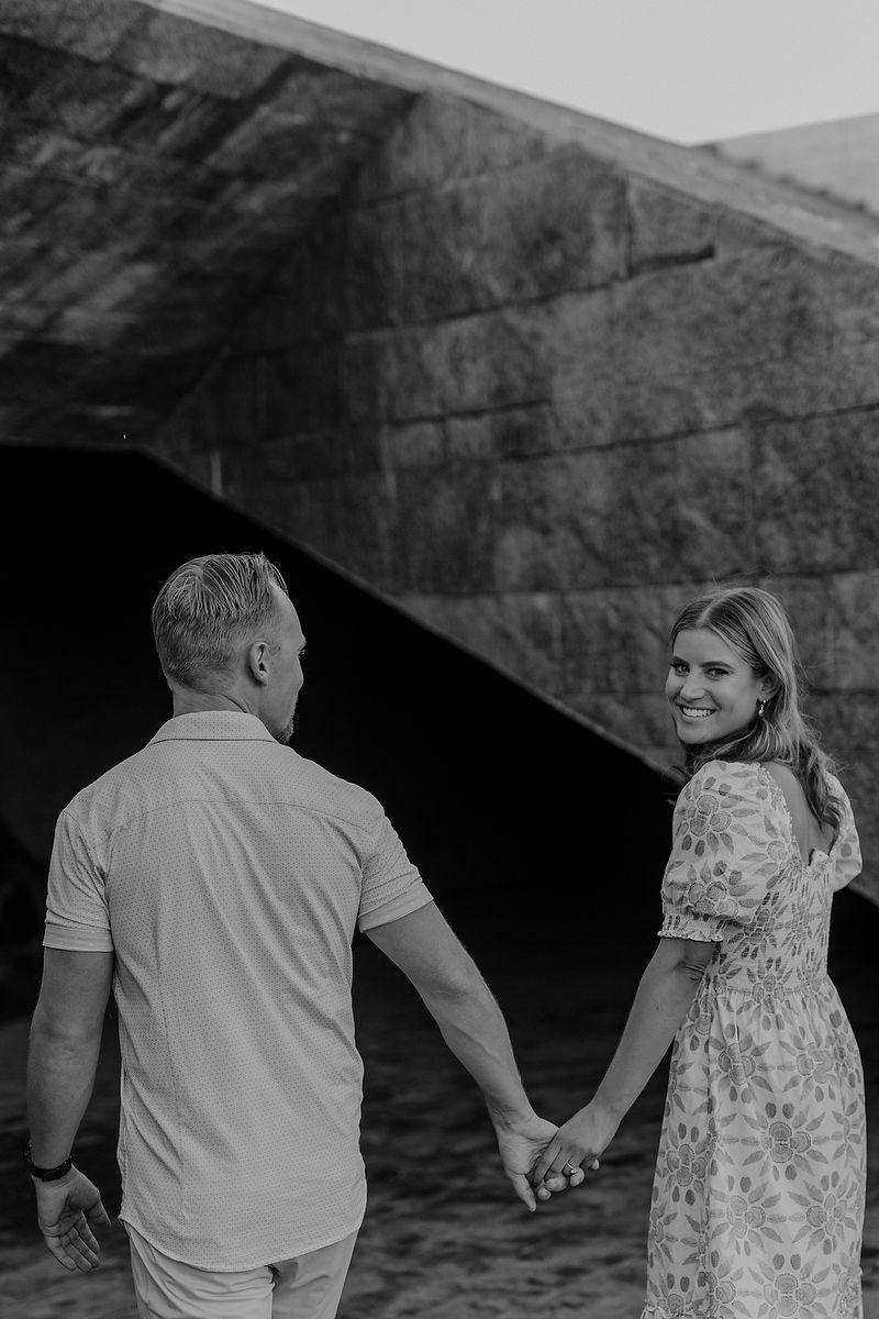 Engagement couple walking at Grand Hyatt Playa del Carmen with elegant architectural background.