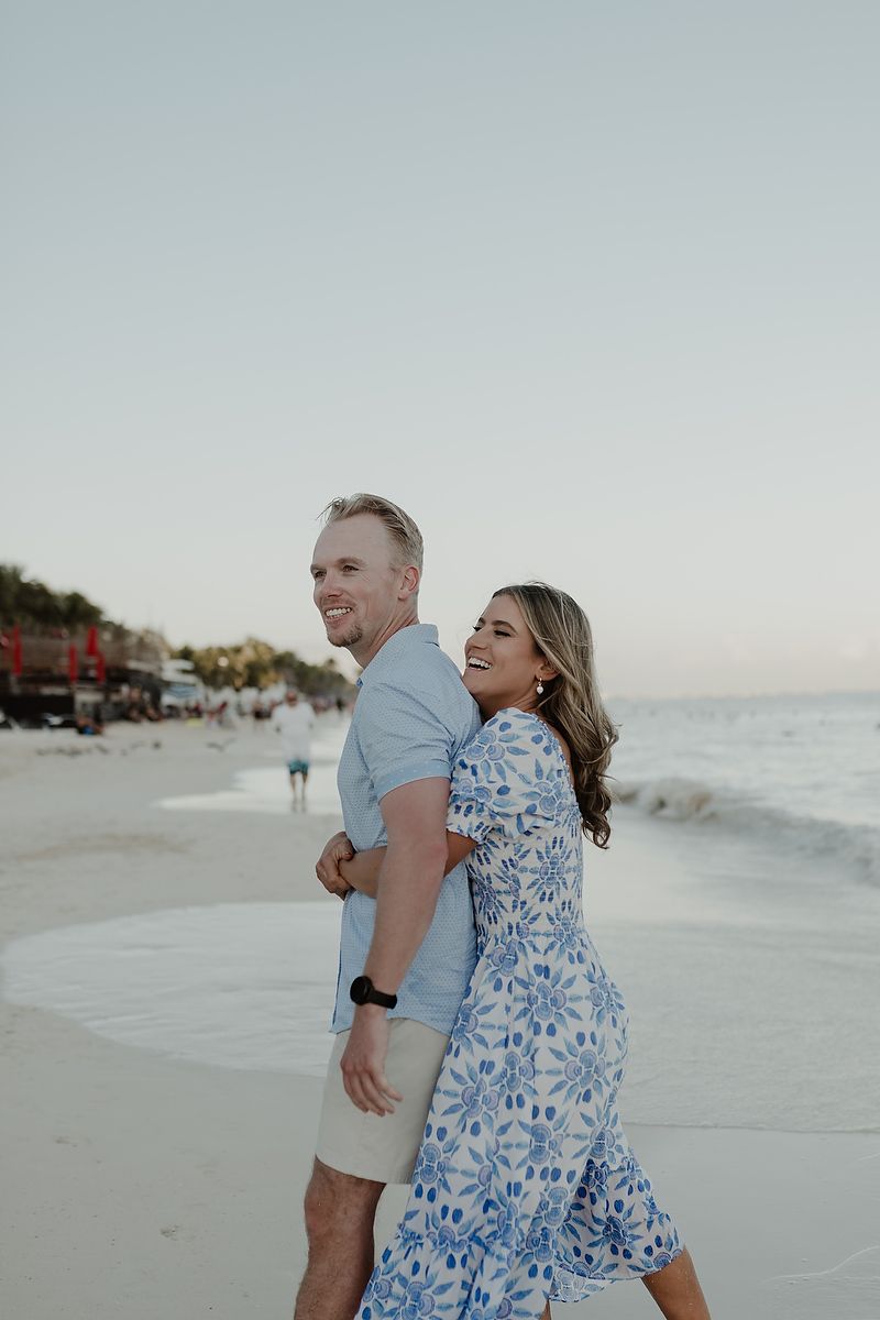 Engagement couple walking by the sea during a luxury photoshoot in the Riviera Maya.