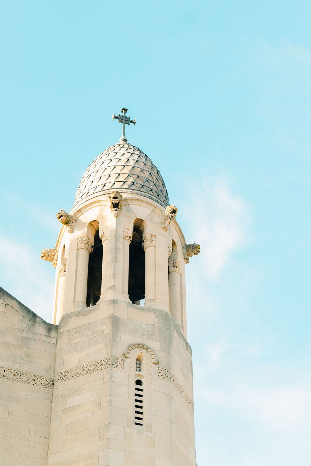 White domed church towers against bright blue sky.