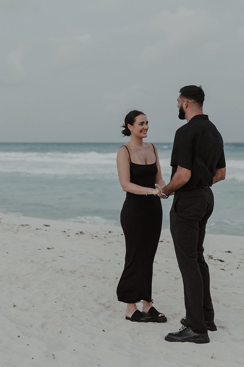 Couple sharing an intimate moment before the surprise proposal on the beach in Cancún.