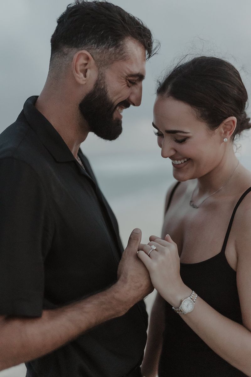 Couple laughing together during an elegant engagement photoshoot in Cancún.