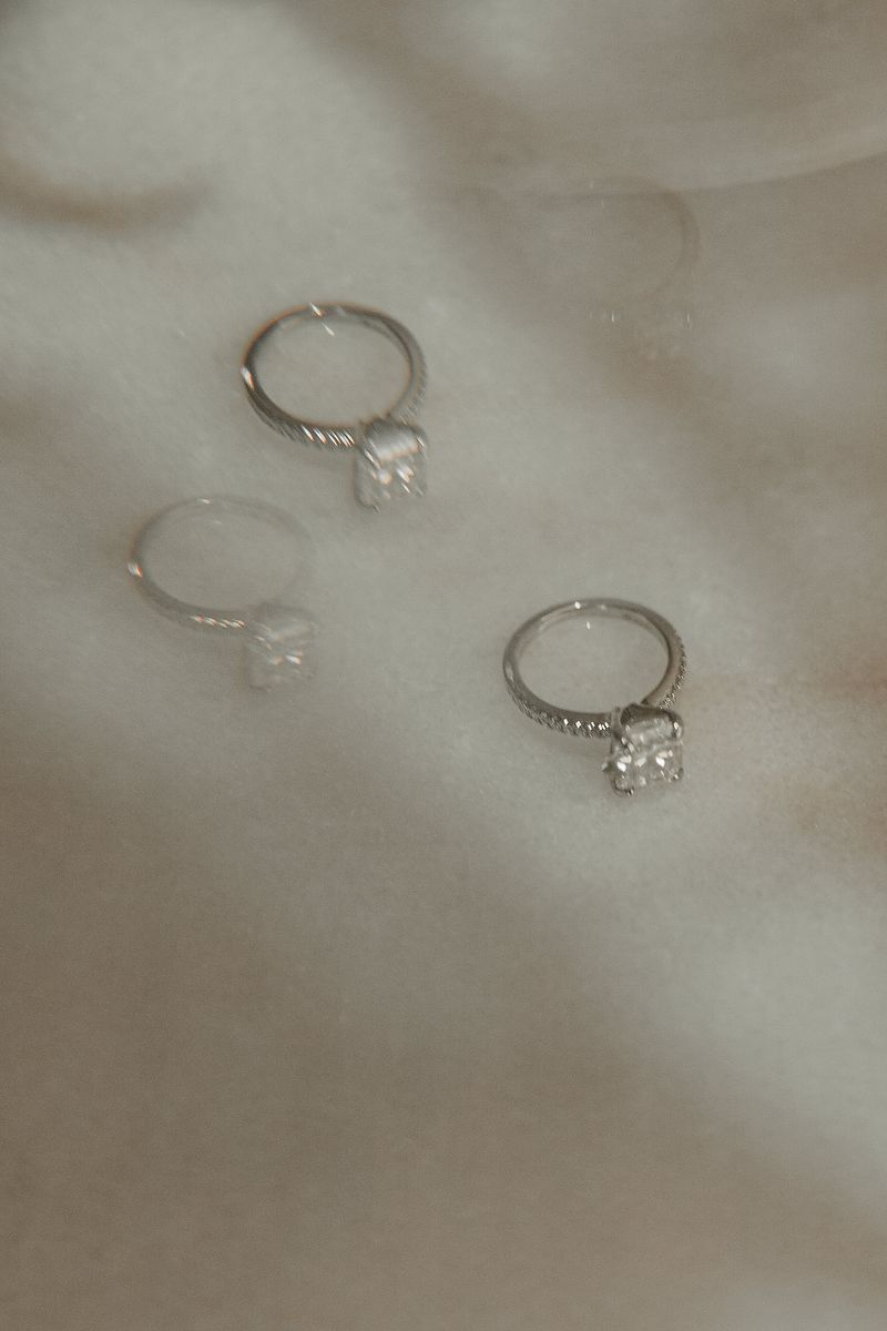 Luxury detail shot of engagement rings on satin during a Riviera Maya photoshoot.