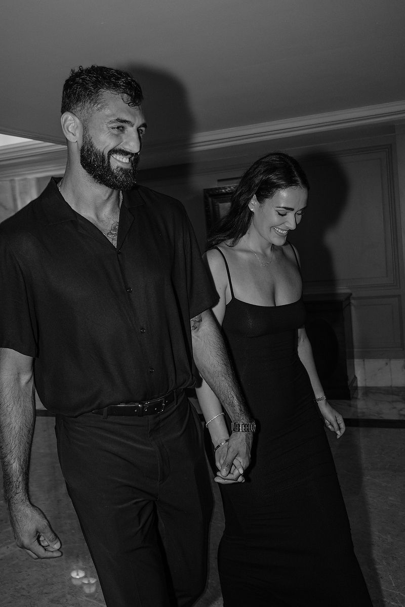 Couple walking hand in hand through Kempinski Cancún after the proposal.