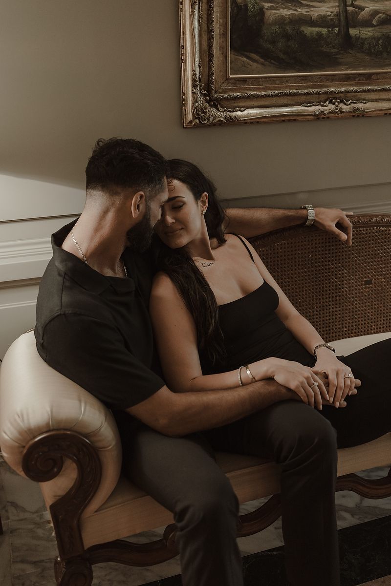 Editorial engagement portrait of a couple sitting in the elegant lounge of Kempinski Hotel Cancún.