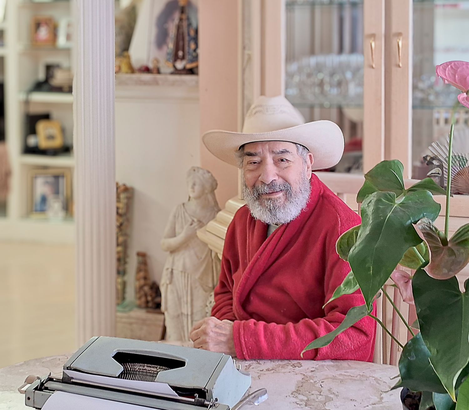 Warm indoor portrait of older man seated by window with soft natural light, photographed by Piret Victoria Ribas.