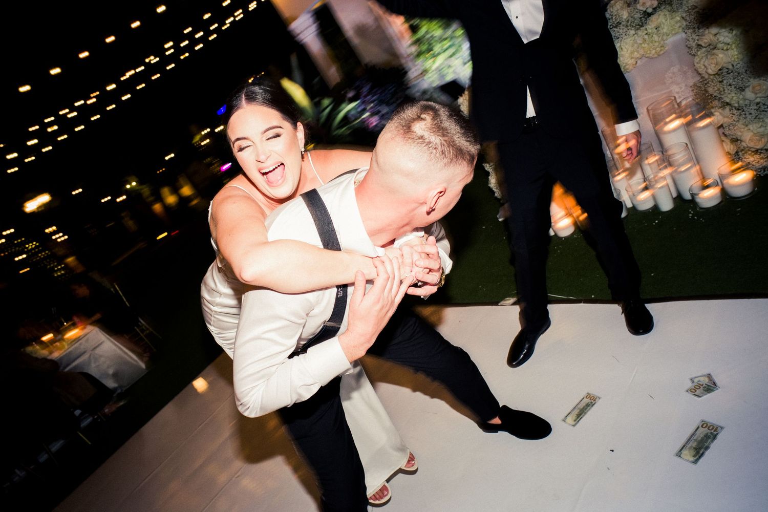 An energetic reception moment captured during a nighttime wedding celebration.