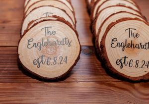 Wooden coaster wedding favors with 'The Englehardt est. 8.24' engraved on them.