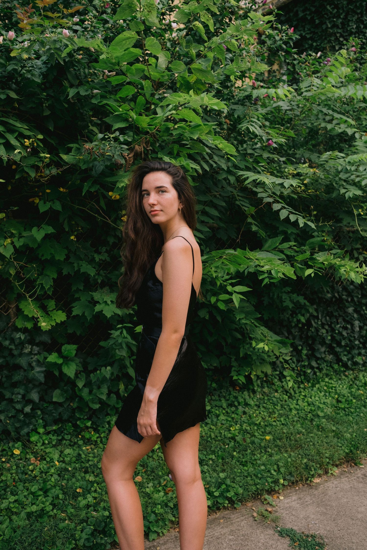 Summer fashion photography in a lush green garden setting.
