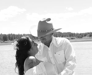 Black and white romantic portrait of newlyweds near lake after wedding ceremony.