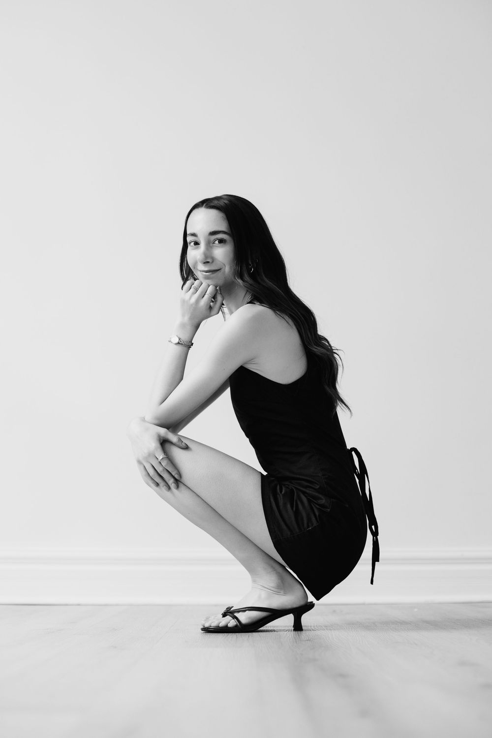 Black and white artistic portraits showing various crouching and sitting poses.