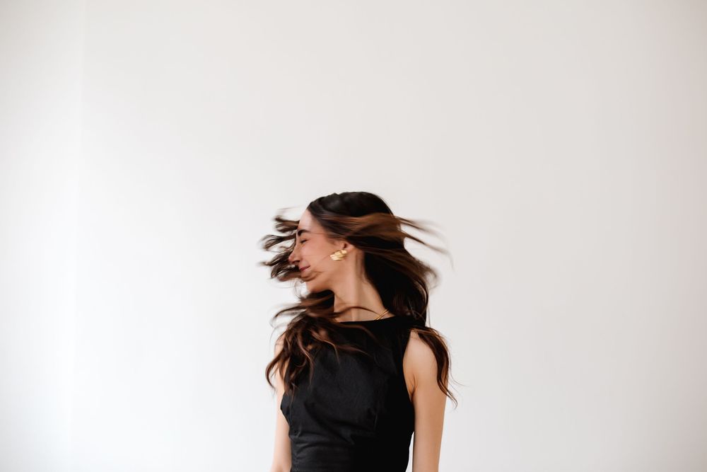 Dynamic portrait series showing movement and energy against white wall.