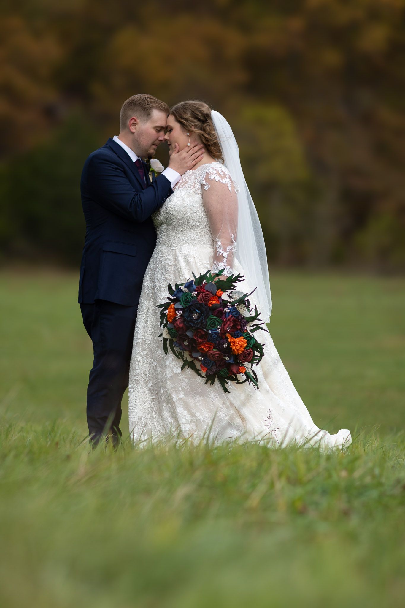 Bride and groom standing together in Missouri field after wedding ceremony