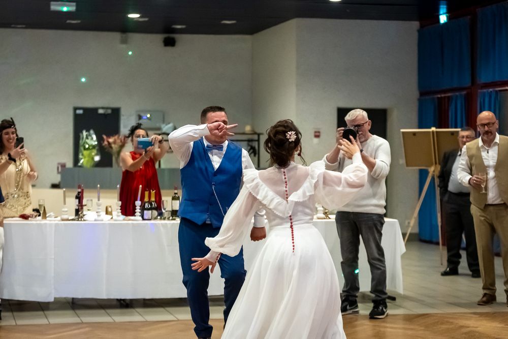 Energetic dance moves being performed during a wedding reception celebration.