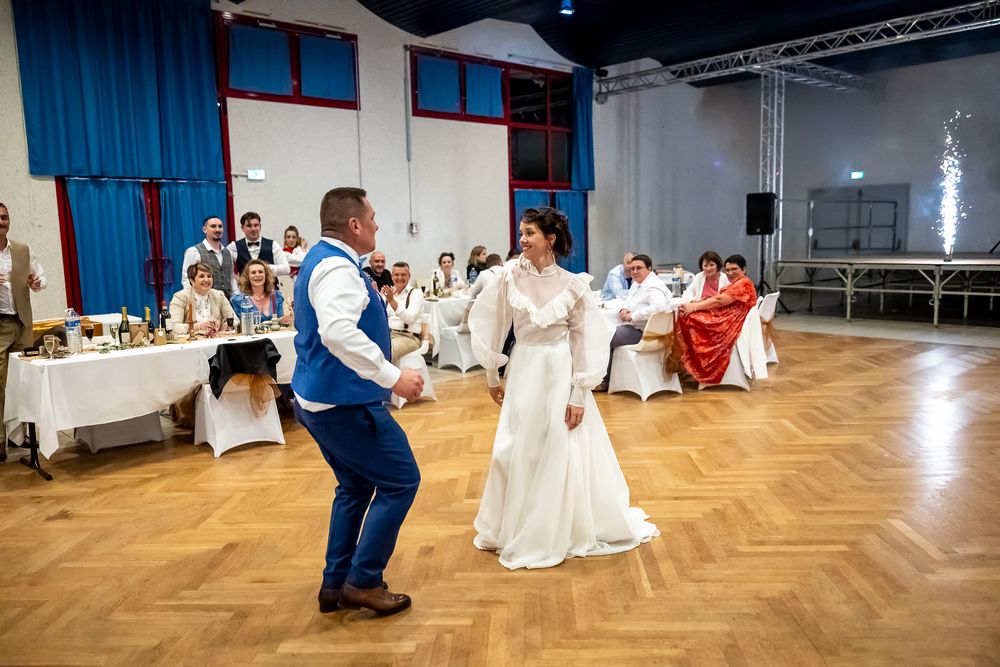 Couple dancing on a parquet floor during their wedding reception.