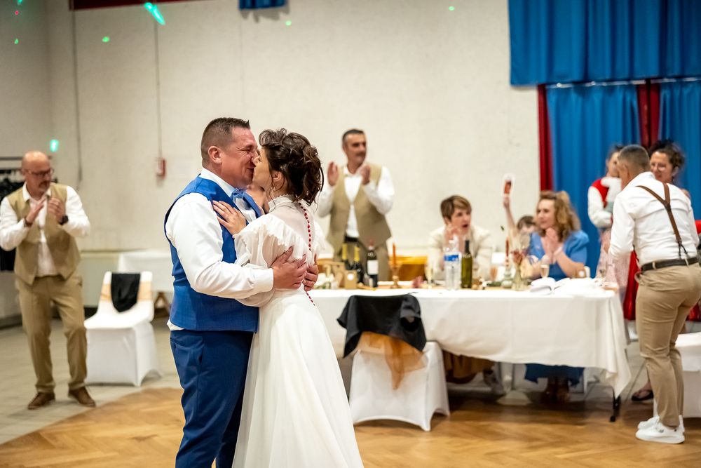 Romantic first dance moment at a wedding reception with guests watching.
