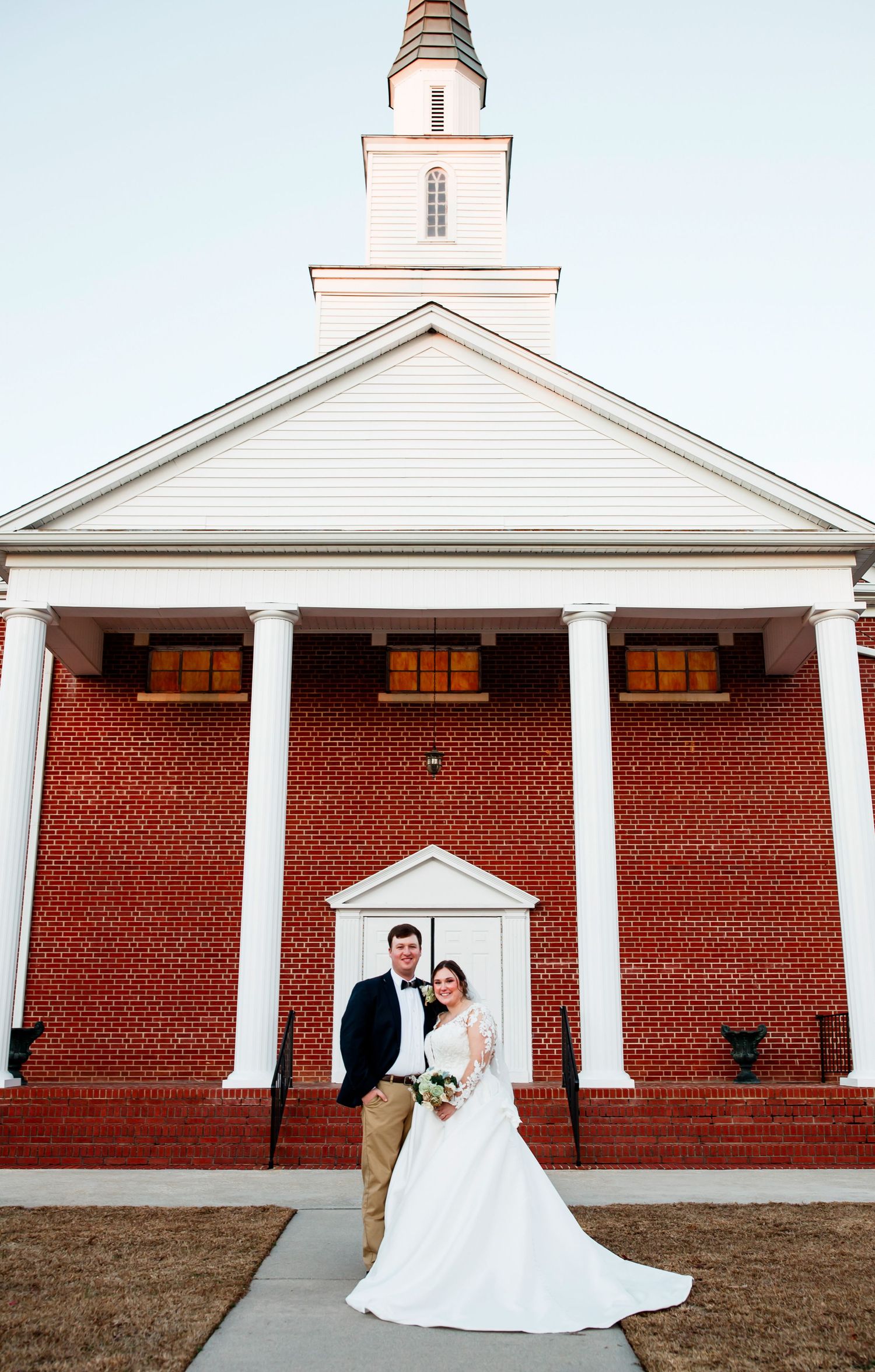 Classic Bride and Groom portrait in front of Church. Amy Eddins Photography