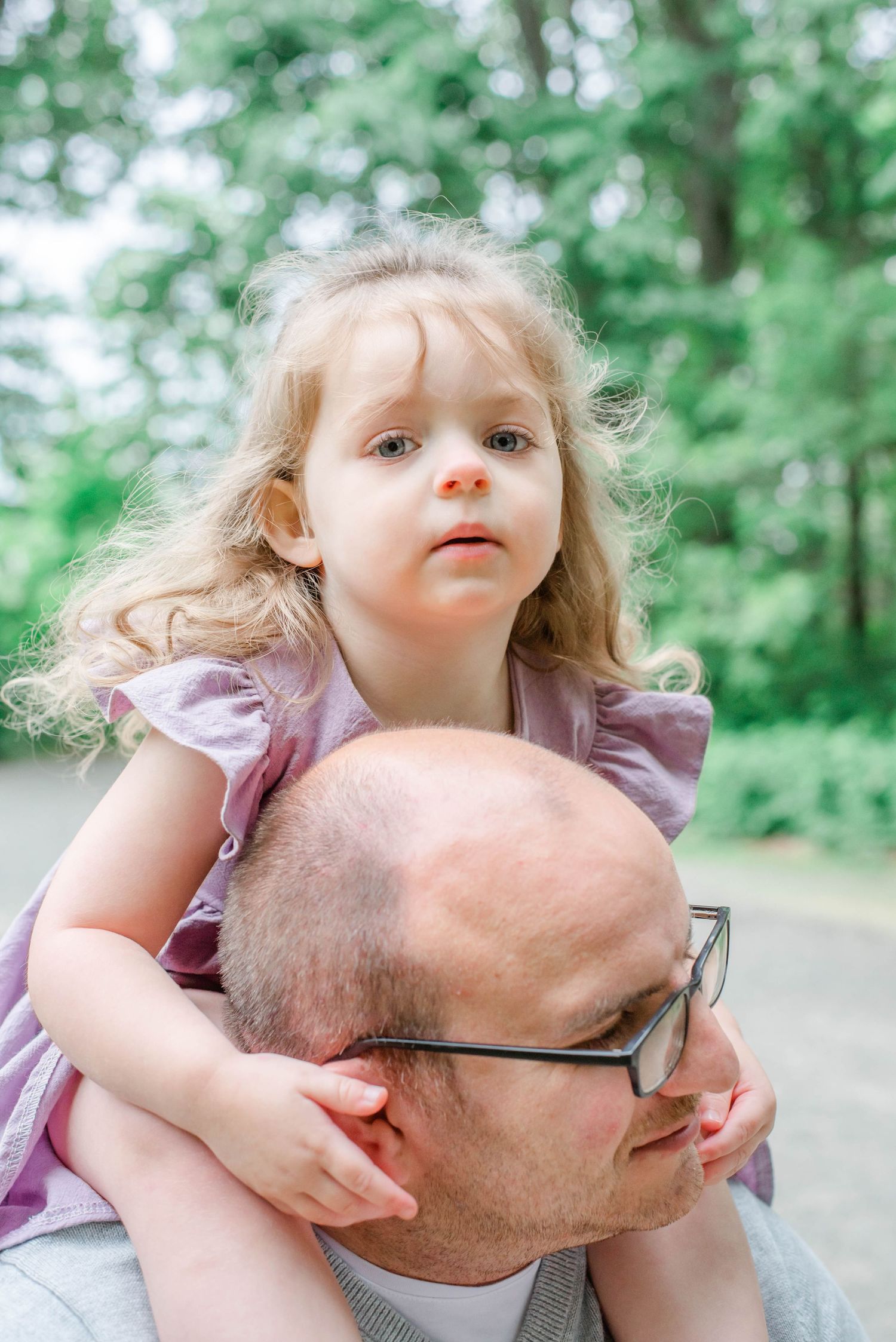 Candid outdoor photography moments captured in a wooded park setting.