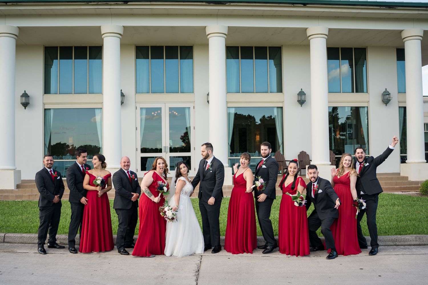 Wedding couple posing by beautiful stained glass windows in a church setting.