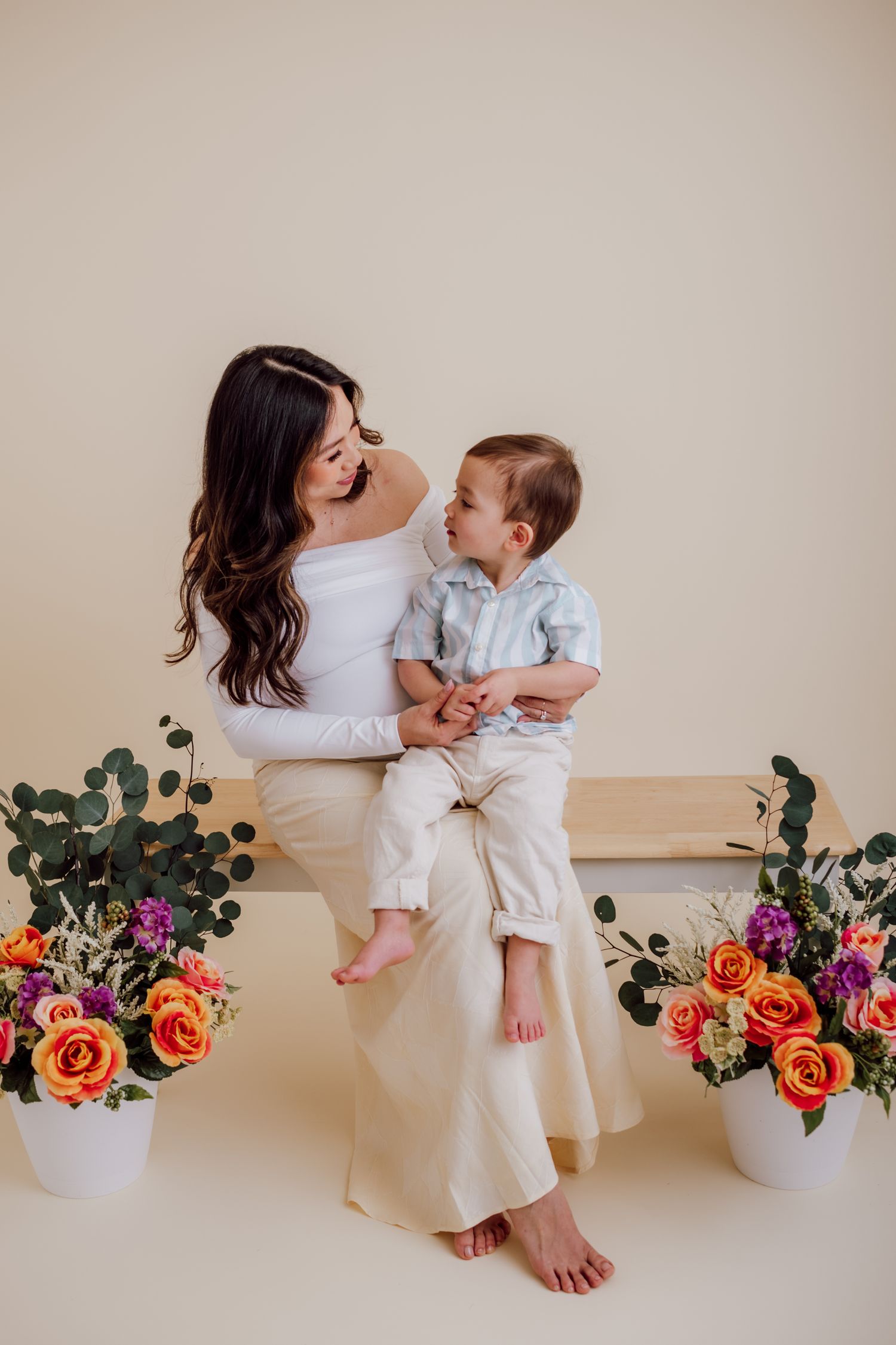 Baby boy on mom's lap with flowers around them for Leesburg and Winchester mini session by Beryl Photography