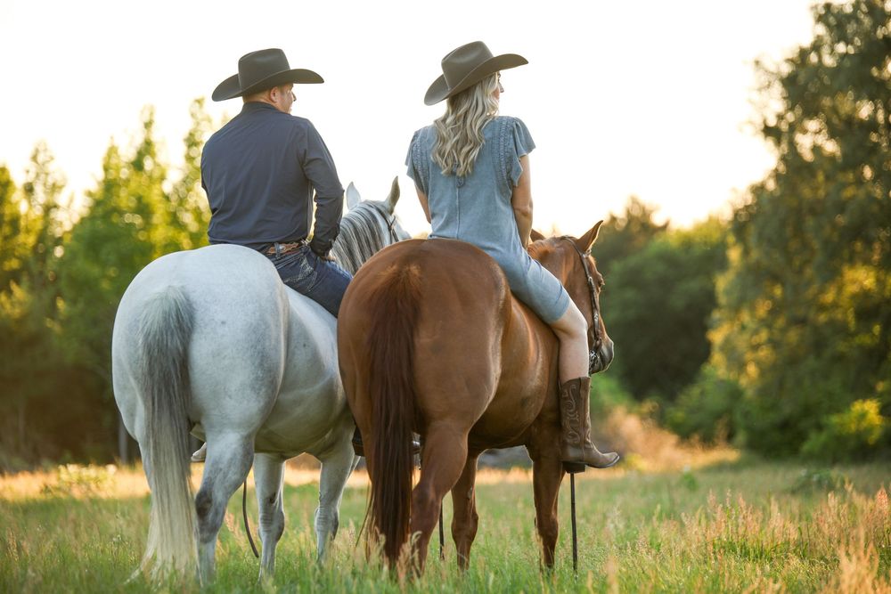 couple on horseback looking away
