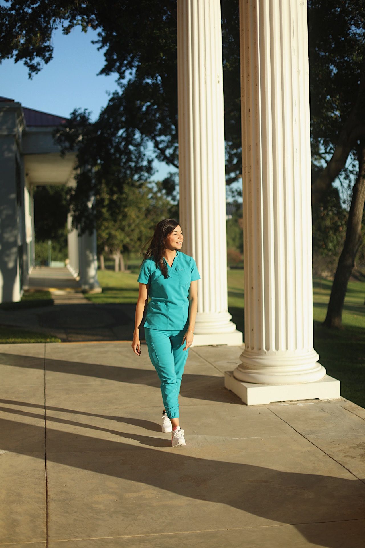 Graduate student walking and staring out in the distance.