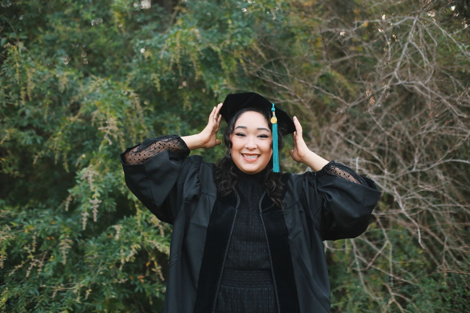 Graduate student holding her cap.