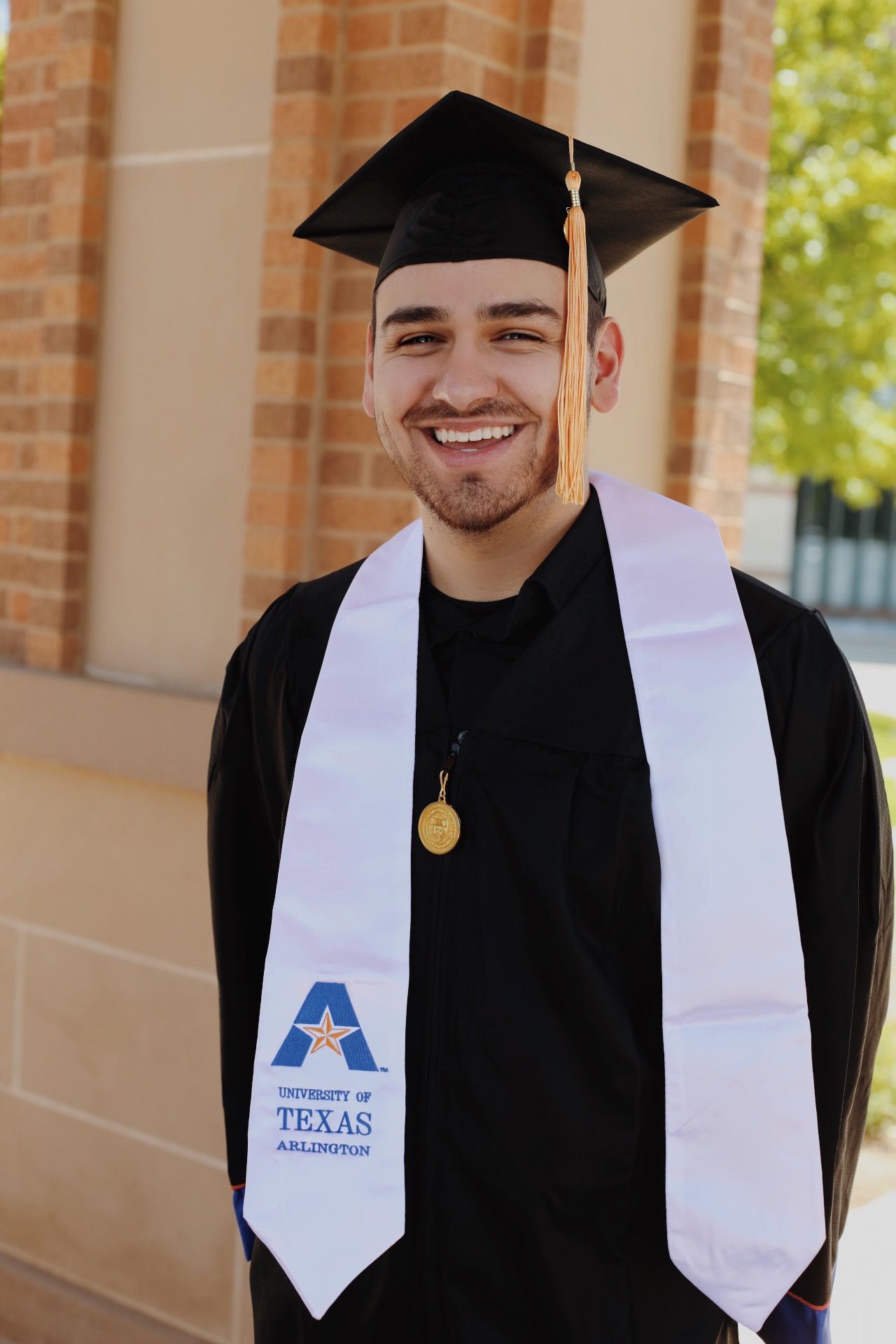 A student graduating and posing.
