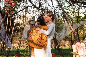 White dress and orange autumn pumpkin create a cozy outdoor photoshoot setting in an orchard.