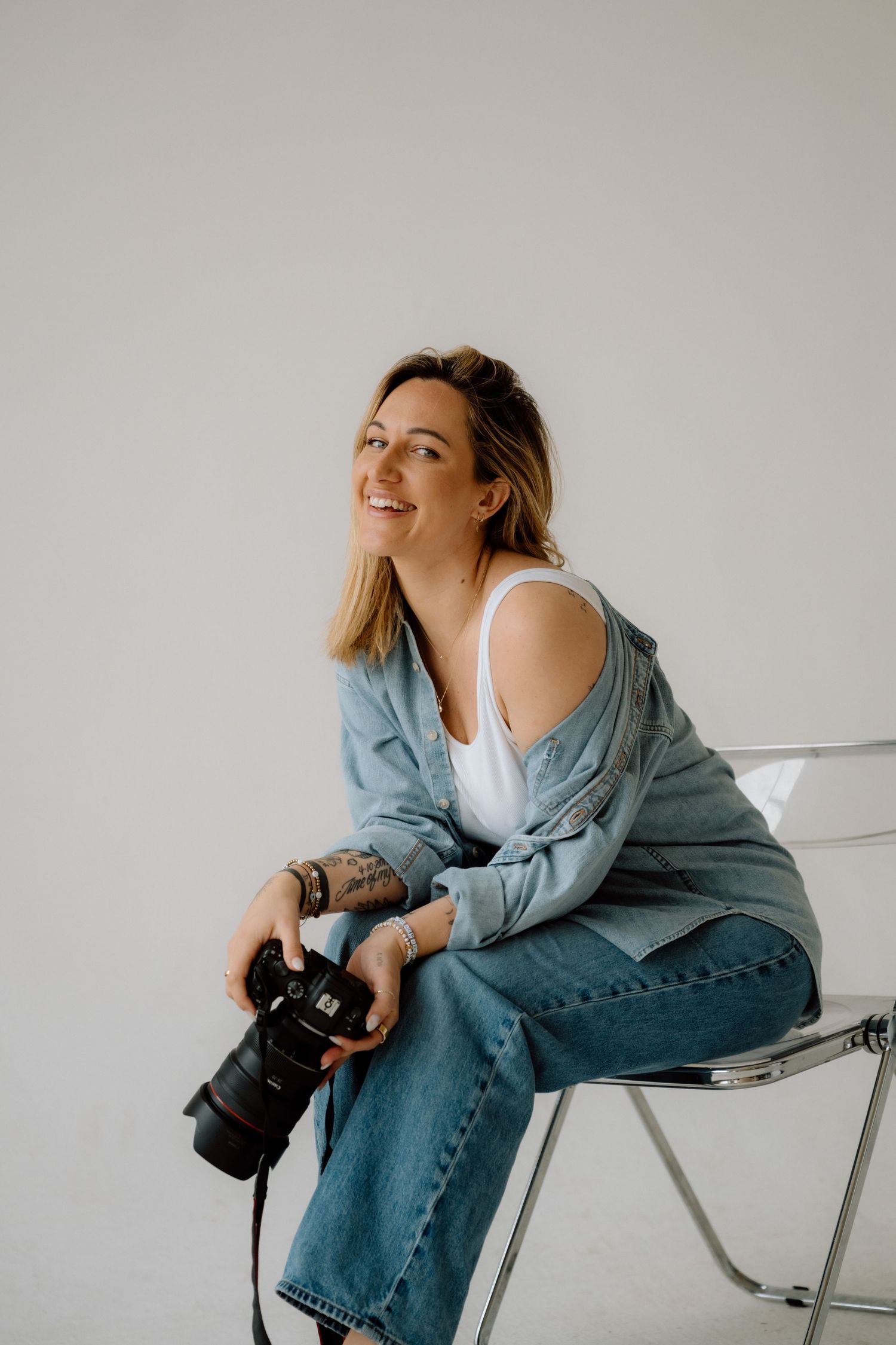 Adélaïde Chantilly captured in a candid moment in her NYC photography studio, holding her camera with natural light streaming in.