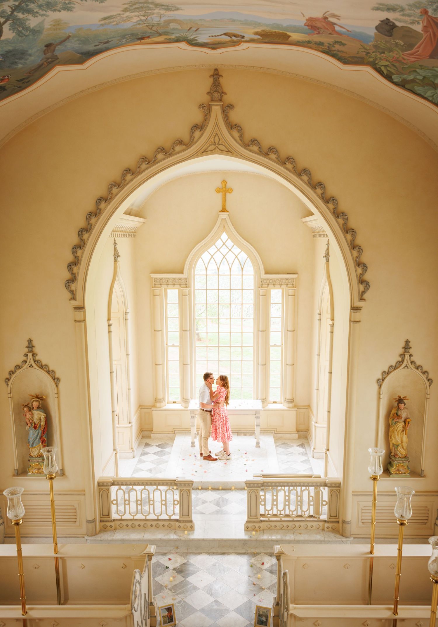 A romantic moment captured in a dreamy chapel interior with Gothic arched windows and ornate religious architectural details.