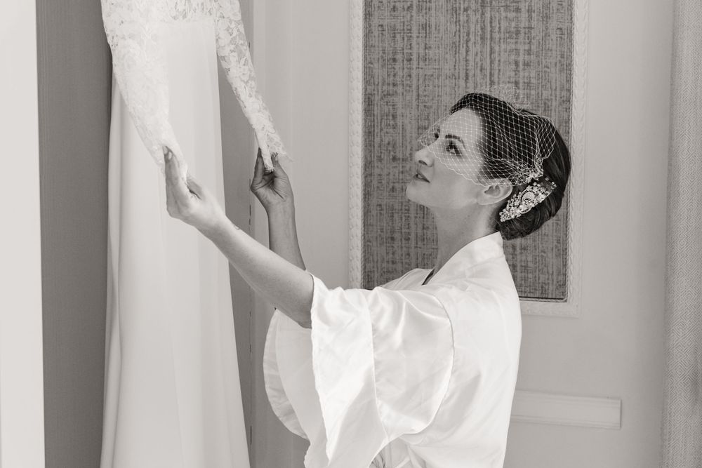 A silhouette sequence of a person in wedding attire getting ready in a bright interior space.