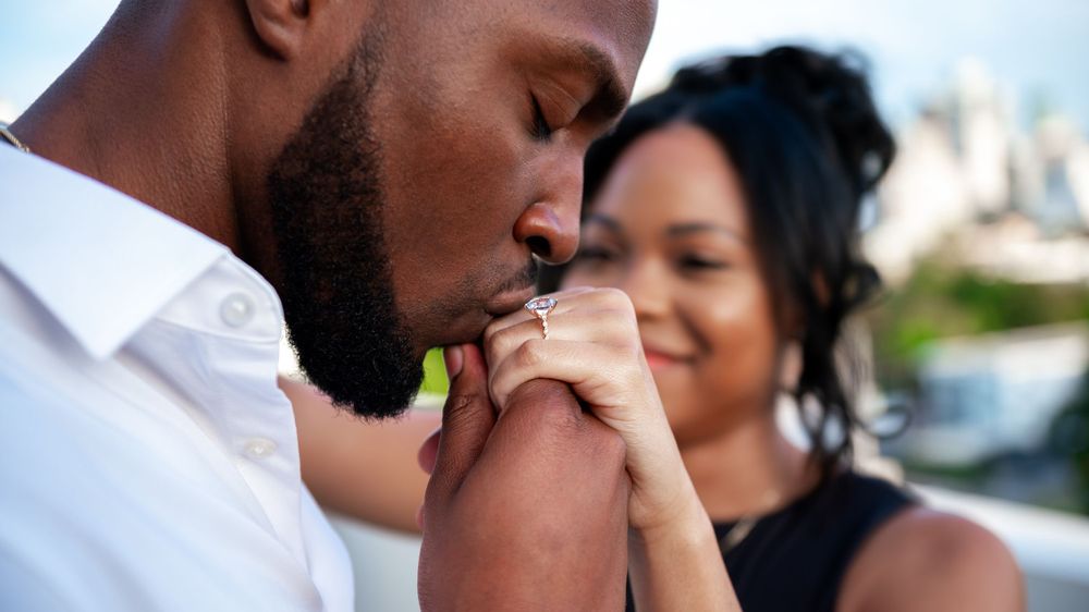 Surprise proposal on a rooftop in Miami. Captured by luxury wedding photographers in Miami