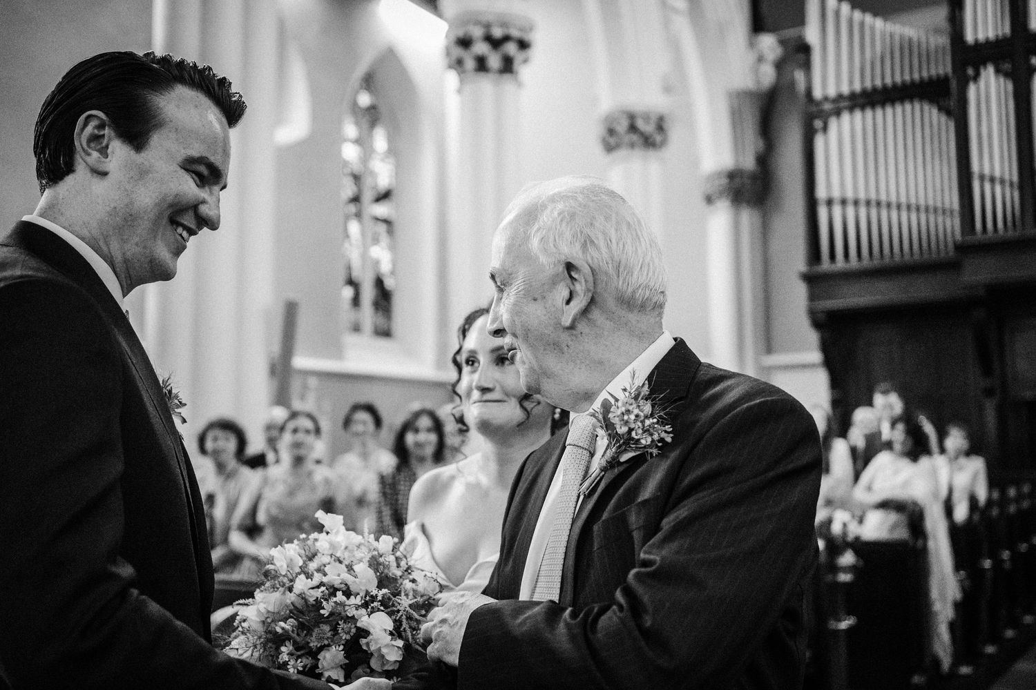 A tender moment between guests and family members during an emotional church wedding ceremony.