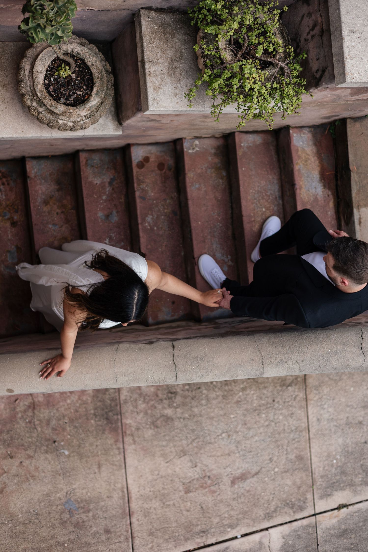 Person lying on tiled surface viewed from above showing creative photography angle.