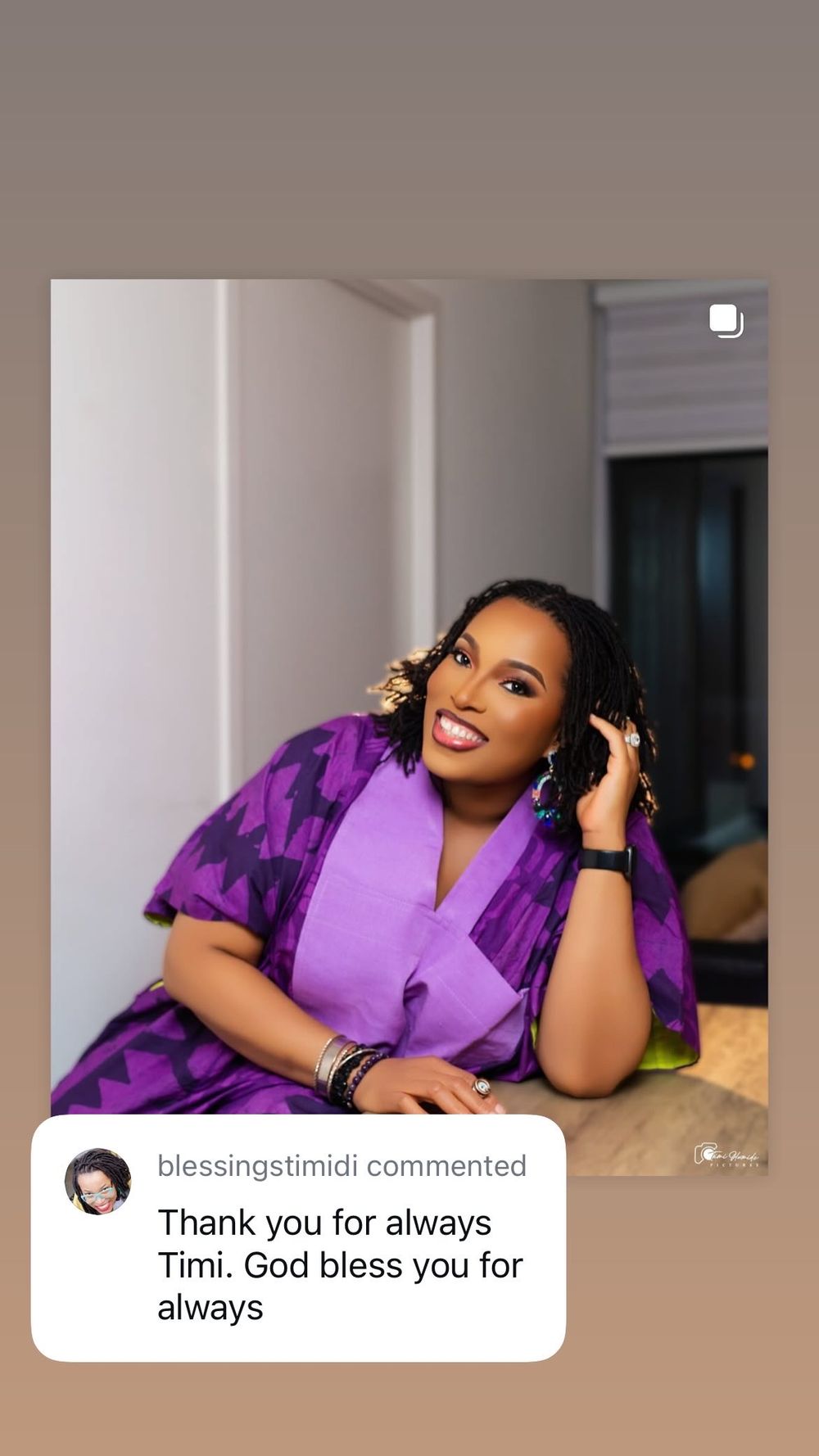Professional photo session showing figure in purple button-up attire lounging on beige cushions in an elegant room setting.