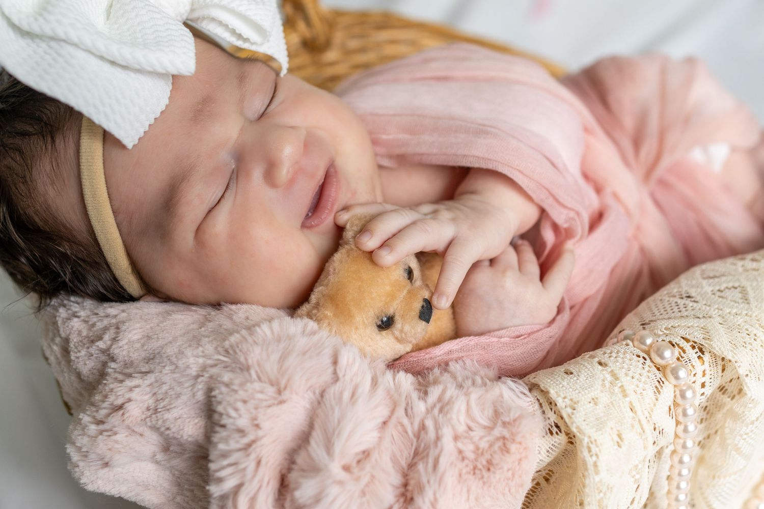 Adorable newborn baby covering face with tiny hand, capturing precious early moments of infancy and newborn photography