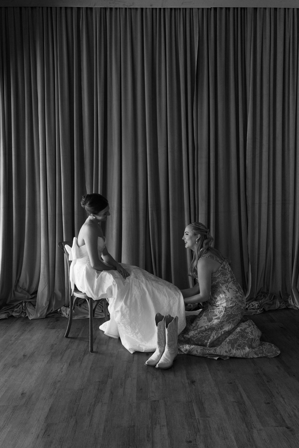 Black and white photo series showing a figure crawling behind curtains in a dramatic sequence.