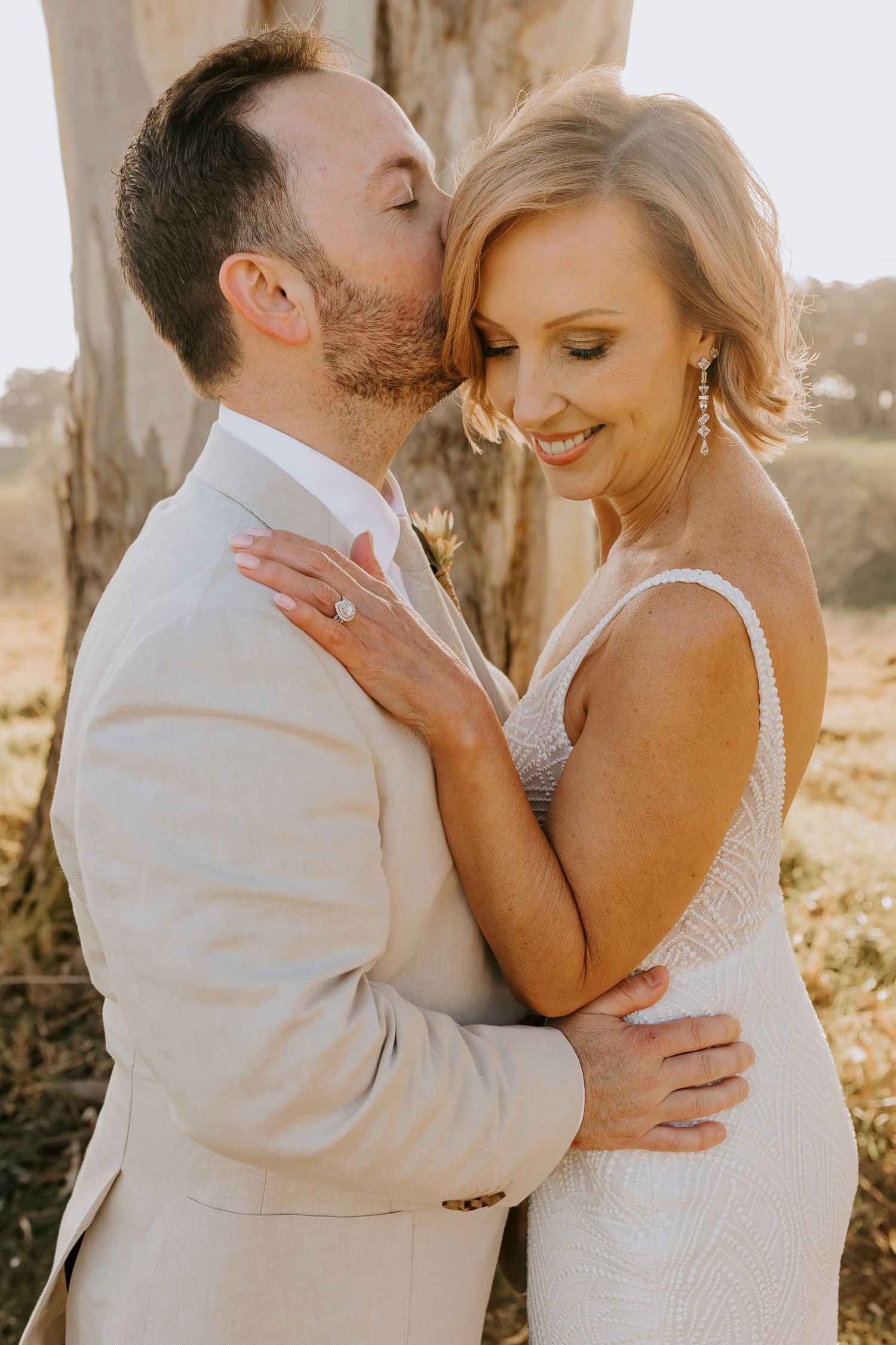 Golden hour wedding portraits with soft natural lighting and intimate poses.